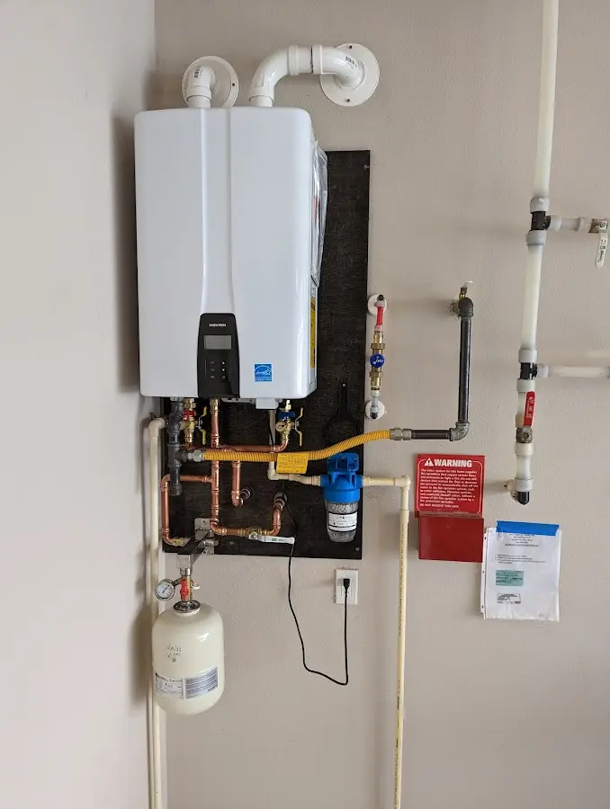 Professional plumber installing copper piping in a Auburn Hills home